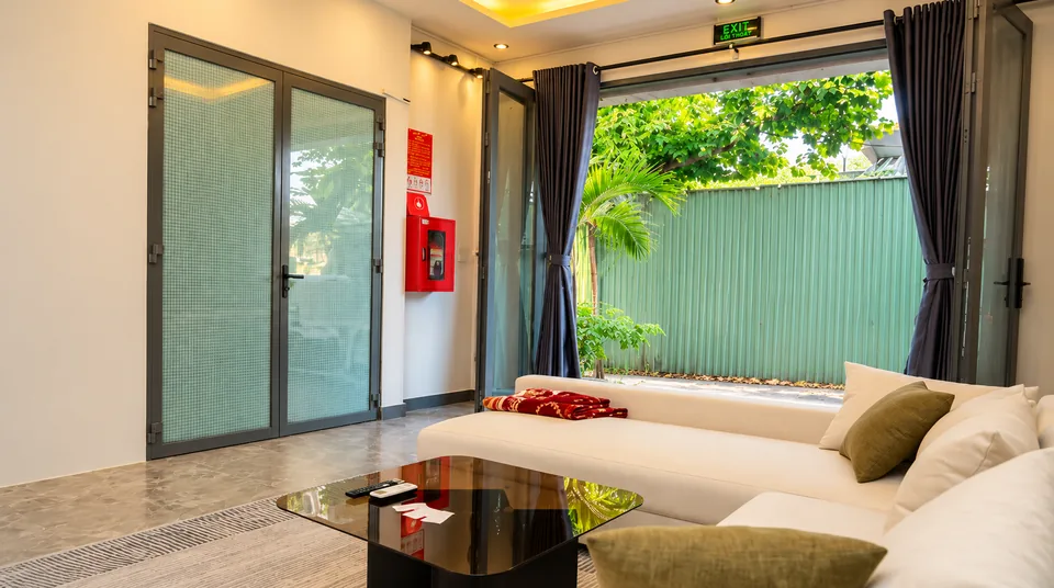 The living room: 40 m², L-sofa and 75-inch 4K TV in your house in Ho Chi Minh City – ASCON LIVING